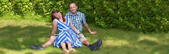 Happy couple sat on the grass