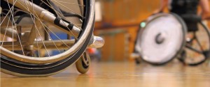 Two men in wheelchairs playing indoor sport